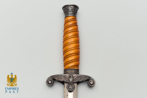 Ceremonial dagger with an orange twisted grip and a metal hilt bearing an eagle and swastika insignia.