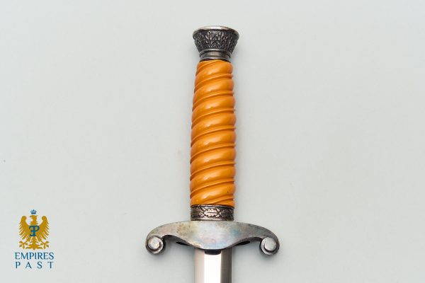 Sword hilt with an orange twisted grip and ornate metal guard; Empires Past watermark in the lower left corner.