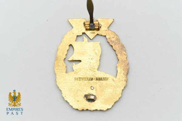 Gold medal pendant with a left-facing silhouette inside an ornate circular frame, inscribed 'Schwerin Berlin' and hanging from a ribbon