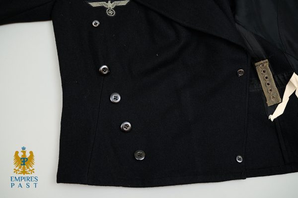 Black wool military-style coat with a row of metal buttons and a small insignia near the collar; Imperial-era logo and text 'EMPires PAST' appear bottom-left on a white background.