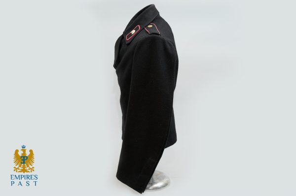 Side view of a black military tunic on a dress form, with red-edged epaulettes; Empires Past logo in the bottom-left corner.