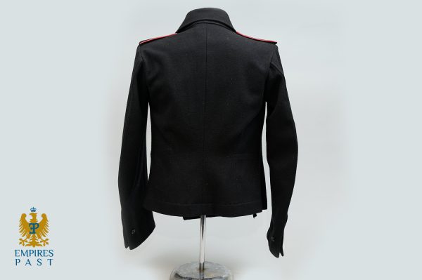Back view of a black military-style jacket on a stand, with red shoulder piping and the Empires Past logo in the bottom-left corner.