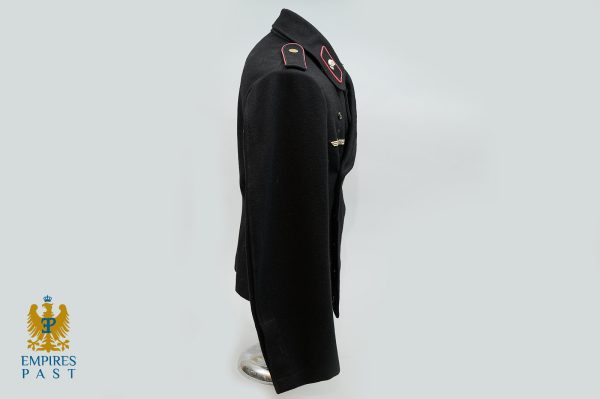 Side view of a black military dress jacket on a mannequin, with red-bordered shoulder boards and a winged badge; Empires Past logo bottom left.