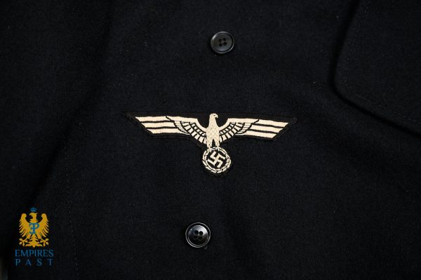 Historical Nazi insignia: an embroidered eagle clutching a swastika on a dark uniform, with a small Empire's Past watermark.
