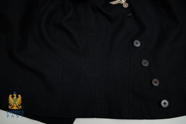 Black military-style jacket with a Nazi eagle insignia on the chest, alongside dark buttons and a blue-and-gold Empires Past watermark at the bottom left.