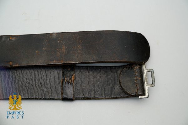 Worn black leather belt with a metal buckle, showing scuffed surface and frayed stitching against a light background.