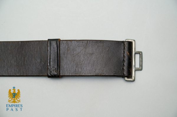 Brown leather belt with a silver metal buckle laid horizontally on a pale surface; Empires Past logo in the bottom-left corner.