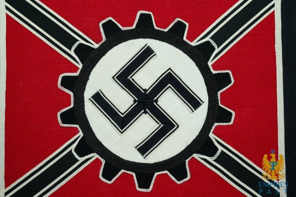 Red flag featuring a gear-shaped emblem with a white circle and black swastika, set on a red background (Nazi symbolism).
