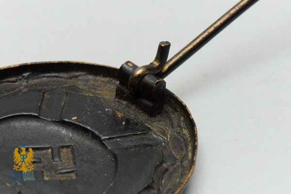 Empires Past 202517361 - Empires Past Close-up of a dusty, rusty circular device with a metal arm attached to a small hinge, showing wear and grime.