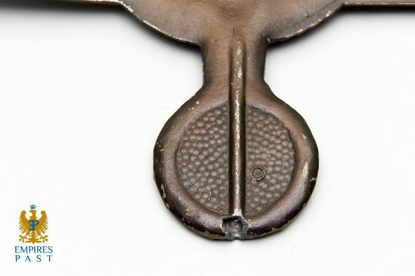 Close-up of a weathered metal sword hilt with a textured circular pommel; Empires Past logo in the lower-left corner.