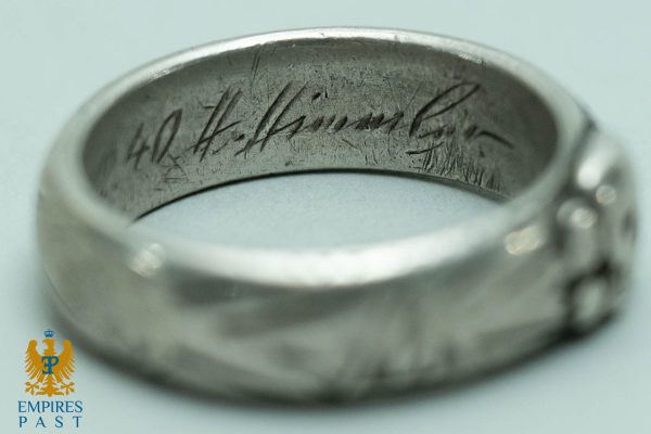 Close-up of a silver ring interior with scratched cursive inscription; Empires Past watermark bottom-left.